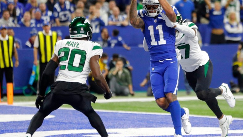 Indianapolis Colts wide receiver Michael Pittman Jr. (11) pulls in a pass in front of New York Jets cornerback Bryce Hall (37) to score a touchdown Thursday, Nov. 4, 2021, during a game against the New York Jets at Lucas Oil Stadium in Indianapolis.