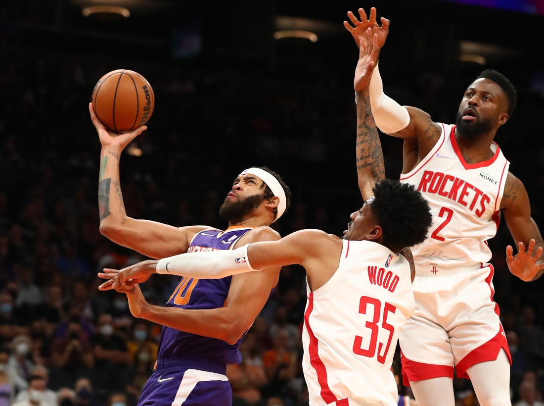 Nov 4, 2021; Phoenix, Arizona, USA; Phoenix Suns center JaVale McGee (00) drives to the basket against Houston Rockets center Christian Wood (35) and forward David Nwaba (2) in the first half at Footprint Center. Mandatory Credit: Mark J. Rebilas-USA TODAY Sports