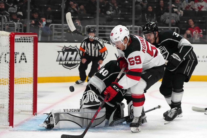 Nov 5, 2021; Los Angeles, California, USA; New Jersey Devils center Janne Kuokkanen (59) takes a shot against LA Kings goaltender Cal Petersen (40)  in the first period at Staples Center. Mandatory Credit: Kirby Lee-USA TODAY Sports