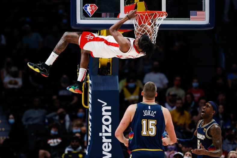 Nov 6, 2021; Denver, Colorado, USA; Houston Rockets guard Jalen Green (0) dunks the ball as Denver Nuggets center Nikola Jokic (15) and forward Will Barton (5) look on in the first quarter at Ball Arena. Mandatory Credit: Isaiah J. Downing-USA TODAY Sports