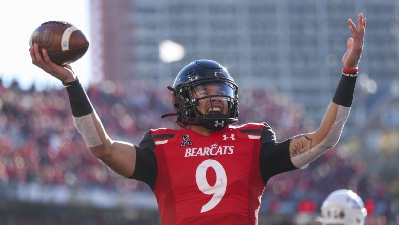 Nov 6, 2021; Cincinnati, Ohio, USA; Cincinnati Bearcats quarterback Desmond Ridder (9) reacts after scoring a touchdown against the Tulsa Golden Hurricane in the first half at Nippert Stadium. Mandatory Credit: Katie Stratman-USA TODAY Sports