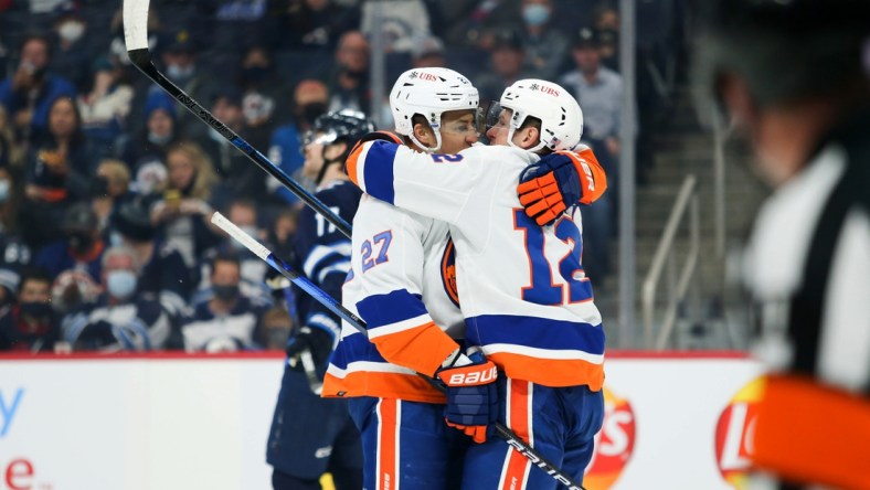 Nov 6, 2021; Winnipeg, Manitoba, CAN; New York Islanders forward Anders Lee (27) celebrates with forward Josh Bailey (12) after scoring a goal against the Winnipeg Jets during the first period at Canada Life Centre. Mandatory Credit: Terrence Lee-USA TODAY Sports