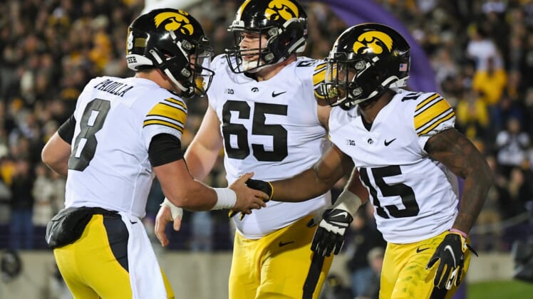 Nov 6, 2021; Evanston, Illinois, USA; Iowa Hawkeyes running back Tyler Goodson (15) and Iowa Hawkeyes quarterback Alex Padilla (8) celebrate after the touchdown in the first half against the Northwestern Wildcats at Ryan Field. Mandatory Credit: Quinn Harris-USA TODAY Sports