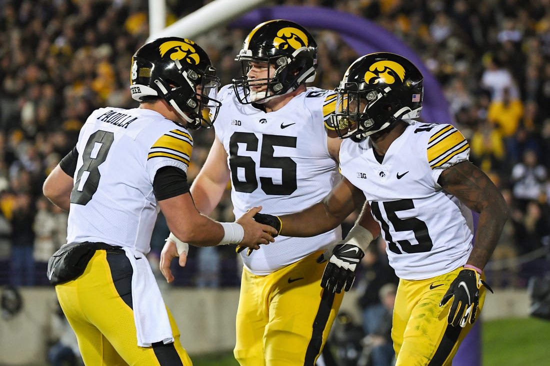 Nov 6, 2021; Evanston, Illinois, USA; Iowa Hawkeyes running back Tyler Goodson (15) and Iowa Hawkeyes quarterback Alex Padilla (8) celebrate after the touchdown in the first half against the Northwestern Wildcats at Ryan Field. Mandatory Credit: Quinn Harris-USA TODAY Sports