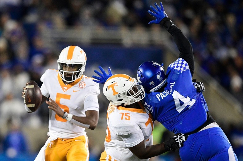 Tennessee quarterback Hendon Hooker (5) looks to pass as Tennessee offensive lineman Jerome Carvin (75) defends against Kentucky defensive end Josh Paschal (4) during an SEC football game between Tennessee and Kentucky at Kroger Field in Lexington, Ky. on Saturday, Nov. 6, 2021.

Kns Tennessee Kentucky Football