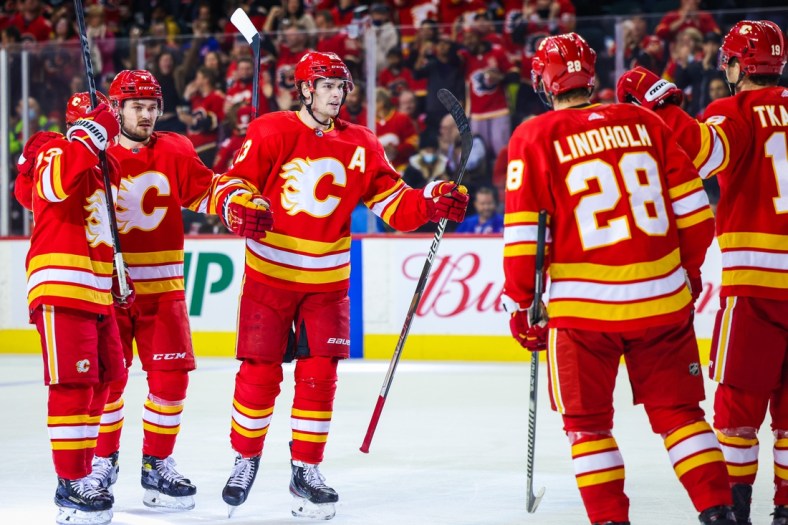 Nov 6, 2021; Calgary, Alberta, CAN; Calgary Flames center Sean Monahan (23) celebrates his goal with teammates against the New York Rangers during the first period at Scotiabank Saddledome. Mandatory Credit: Sergei Belski-USA TODAY Sports
