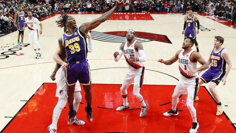 Nov 6, 2021; Portland, Oregon, USA; Los Angeles Lakers center Dwight Howard (39) grabs a rebound as Portland Trail Blazers center Jusuf Nurkic (27, left) defends during the first half at Moda Center. Mandatory Credit: Soobum Im-USA TODAY Sports