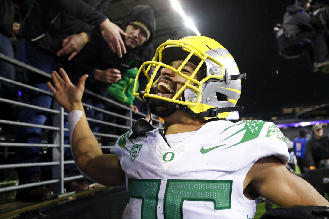 Nov 6, 2021; Seattle, Washington, USA; Oregon Ducks running back Travis Dye (26) celebrates with fans following a 26-16 victory against the Washington Huskies at Alaska Airlines Field at Husky Stadium. Mandatory Credit: Joe Nicholson-USA TODAY Sports