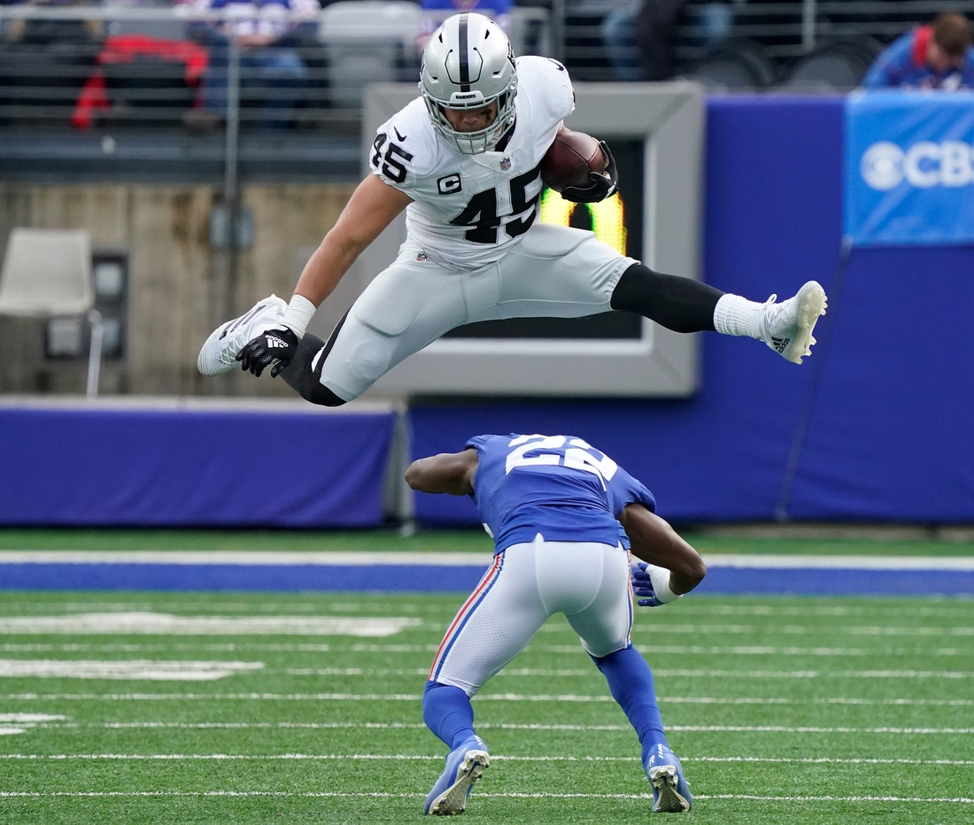 Nov 7, 2021; East Rutherford, N.J., USA;  
Las Vegas Raiders fullback Alec Ingold (45) hurdles over New York Giants cornerback Adoree' Jackson (22) for yards in the second quarter at MetLife Stadium. Mandatory Credit: Robert Deutsch-USA TODAY Sports