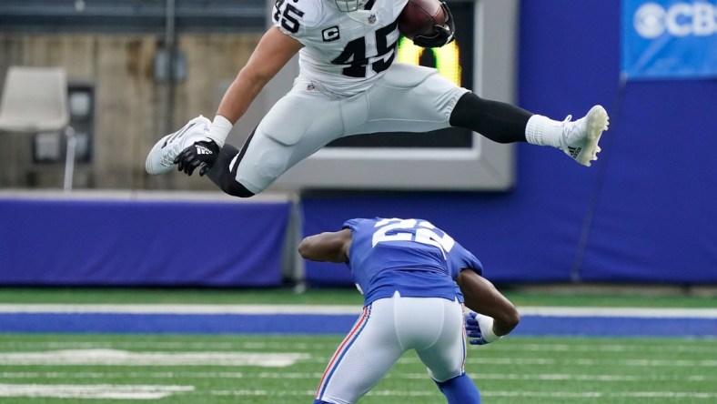 Nov 7, 2021; East Rutherford, N.J., USA;  
Las Vegas Raiders fullback Alec Ingold (45) hurdles over New York Giants cornerback Adoree' Jackson (22) for yards in the second quarter at MetLife Stadium. Mandatory Credit: Robert Deutsch-USA TODAY Sports