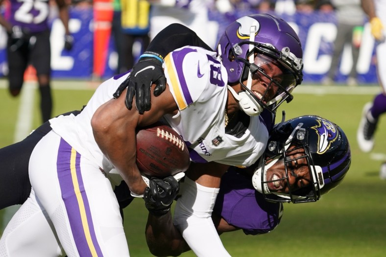 Nov 7, 2021; Baltimore, Maryland, USA; Minnesota Vikings wide receiver Justin Jefferson (18) tackled in the second quarter by Baltimore Ravens tackle Cedric Ogbuehi (67) following a catch against the Baltimore Ravens at M&T Bank Stadium. Mandatory Credit: Mitch Stringer-USA TODAY Sports