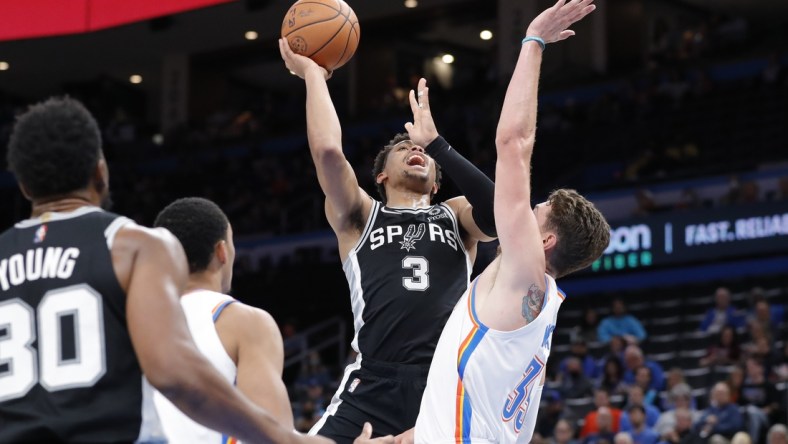 Nov 7, 2021; Oklahoma City, Oklahoma, USA; San Antonio Spurs forward Keldon Johnson (3) goes up for a basket as Oklahoma City Thunder center Mike Muscala (33) defends during the second quarter at Paycom Center. Mandatory Credit: Alonzo Adams-USA TODAY Sports