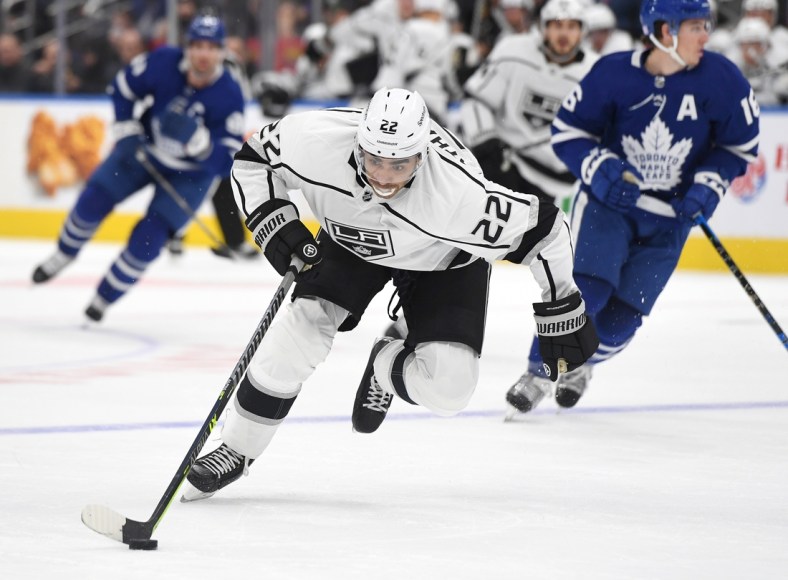 Nov 8, 2021; Toronto, Ontario, CAN;    Los Angeles Kings forward Andreas Athanasiou (22) rushes the puck up ice en route to scoring a goal against Toronto Maple Leafs in the first period at Scotiabank Arena. Mandatory Credit: Dan Hamilton-USA TODAY Sports