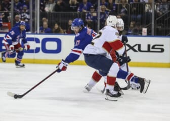 Nov 8, 2021; New York, New York, USA;  New York Rangers center Kevin Rooney (17) controls the puck in the second period at Madison Square Garden. Mandatory Credit: Wendell Cruz-USA TODAY Sports