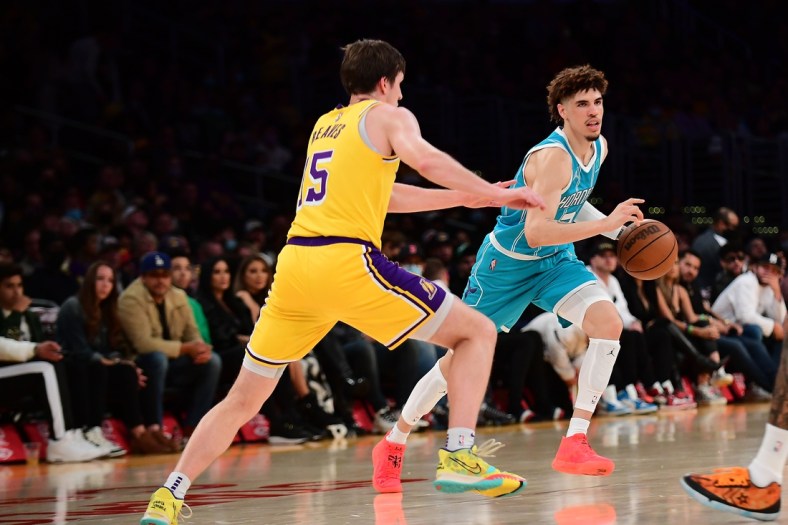 Nov 8, 2021; Los Angeles, California, USA; Charlotte Hornets guard LaMelo Ball (2) moves the ball against Los Angeles Lakers guard Austin Reaves (15) during the first half at Staples Center. Mandatory Credit: Gary A. Vasquez-USA TODAY Sports