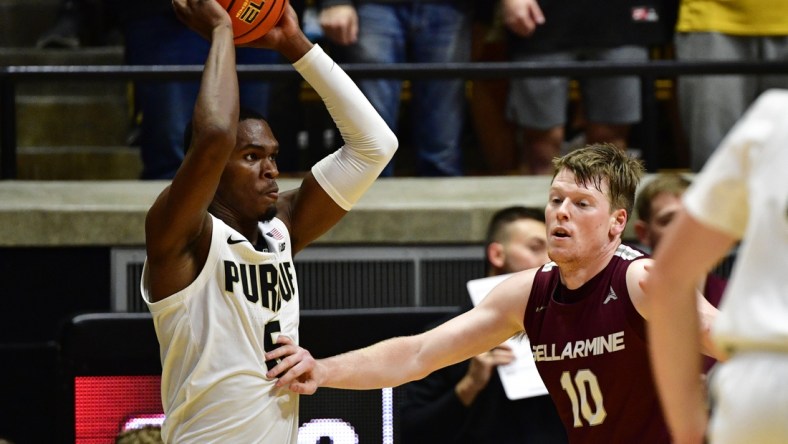 Nov 9, 2021; West Lafayette, Indiana, USA; Purdue Boilermakers guard Brandon Newman (5) looks for an open teammate in front of Bellarmine Knights guard Garrett Tipton (10) during the first half at Mackey Arena. Credit: Marc Lebryk-USA TODAY Sports