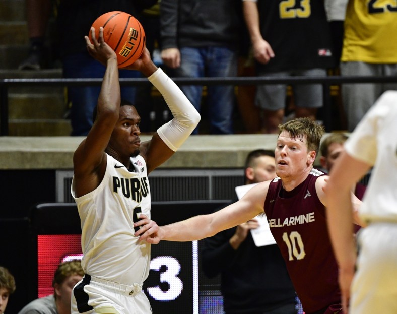 Nov 9, 2021; West Lafayette, Indiana, USA; Purdue Boilermakers guard Brandon Newman (5) looks for an open teammate in front of Bellarmine Knights guard Garrett Tipton (10) during the first half at Mackey Arena. Credit: Marc Lebryk-USA TODAY Sports
