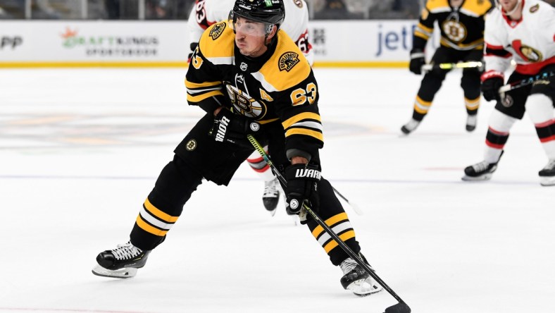 Nov 9, 2021; Boston, Massachusetts, USA; Boston Bruins center Brad Marchand (63) skates with the puck against the Ottawa Senators during the first period at the TD Garden. Mandatory Credit: Brian Fluharty-USA TODAY Sports