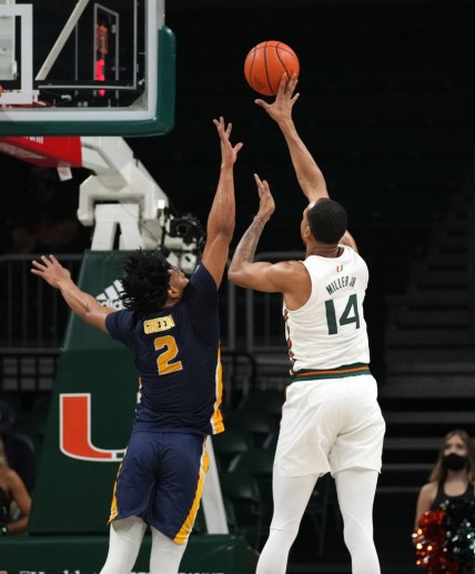 Nov 9, 2021; Coral Gables, Florida, USA; Miami Hurricanes center Rodney Miller Jr. (14) shoots the ball over Canisius Golden Griffins forward Malek Green (2) during the first half at Watsco Center. Mandatory Credit: Jasen Vinlove-USA TODAY Sports