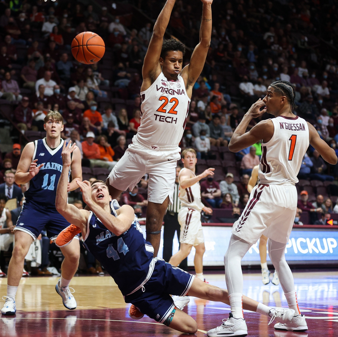 Nov 9, 2021; Blacksburg, Virginia, USA; Maine Black Bears forward Peter Filipovity (44) tosses up a shot guarded by Virginia Tech Hokies forward Keve Aluma (22) at Cassell Coliseum. Mandatory Credit: Ryan Hunt-USA TODAY Sports