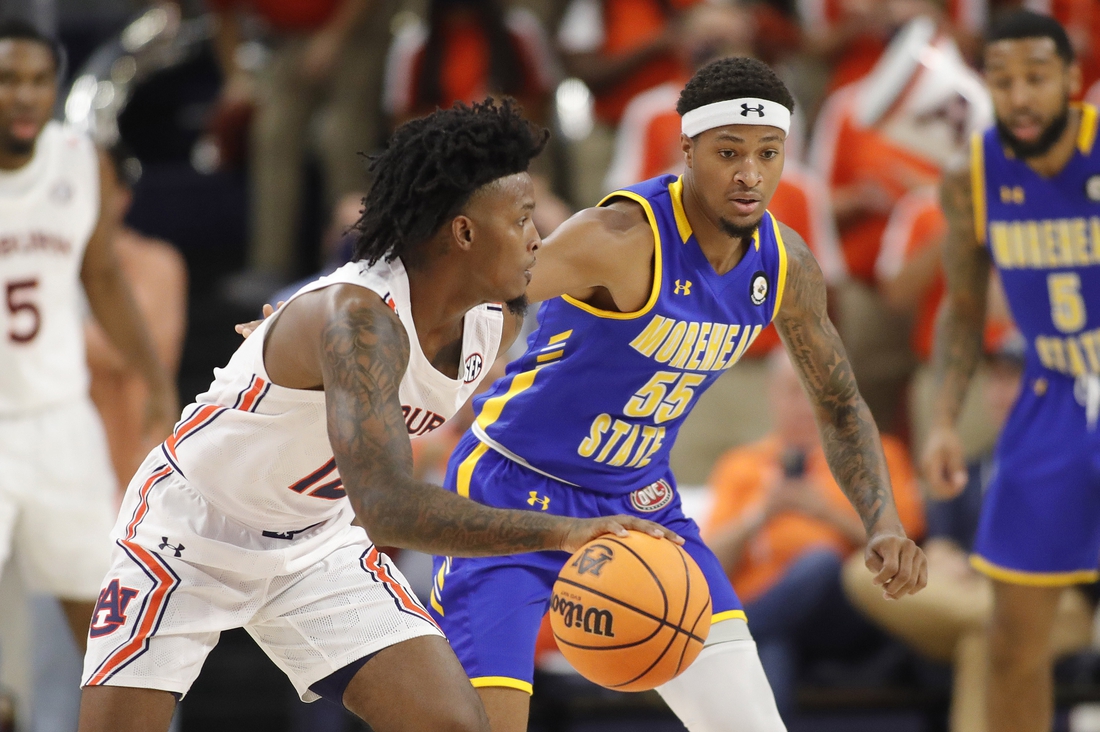 Nov 9, 2021; Auburn, Alabama, USA;  Auburn Tigers guard Zep Jasper (12) is guarded by Morehead State Eagles guard Ta'lon Cooper (55) during the first half at Auburn Arena. Mandatory Credit: John Reed-USA TODAY Sports