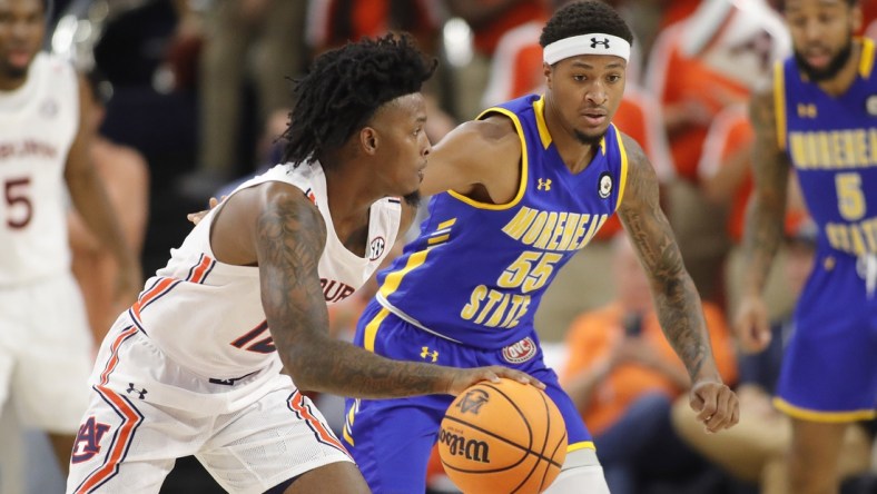 Nov 9, 2021; Auburn, Alabama, USA;  Auburn Tigers guard Zep Jasper (12) is guarded by Morehead State Eagles guard Ta'lon Cooper (55) during the first half at Auburn Arena. Mandatory Credit: John Reed-USA TODAY Sports