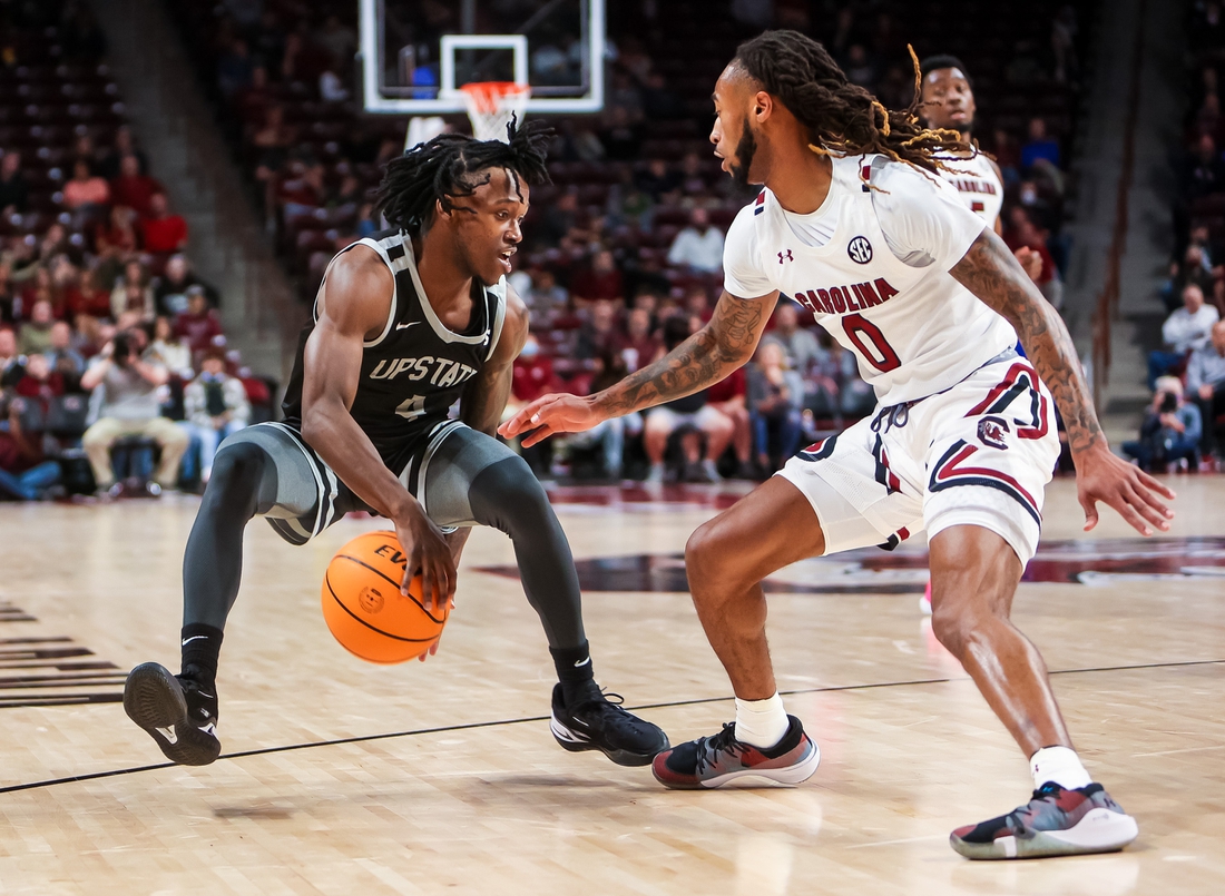 Nov 9, 2021; Columbia, South Carolina, USA; South Carolina Upstate Spartans guard Jalen Breazeale (4) brings the ball up against South Carolina Gamecocks guard James Reese V (0) in the second half at Colonial Life Arena. Mandatory Credit: Jeff Blake-USA TODAY Sports