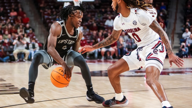 Nov 9, 2021; Columbia, South Carolina, USA; South Carolina Upstate Spartans guard Jalen Breazeale (4) brings the ball up against South Carolina Gamecocks guard James Reese V (0) in the second half at Colonial Life Arena. Mandatory Credit: Jeff Blake-USA TODAY Sports