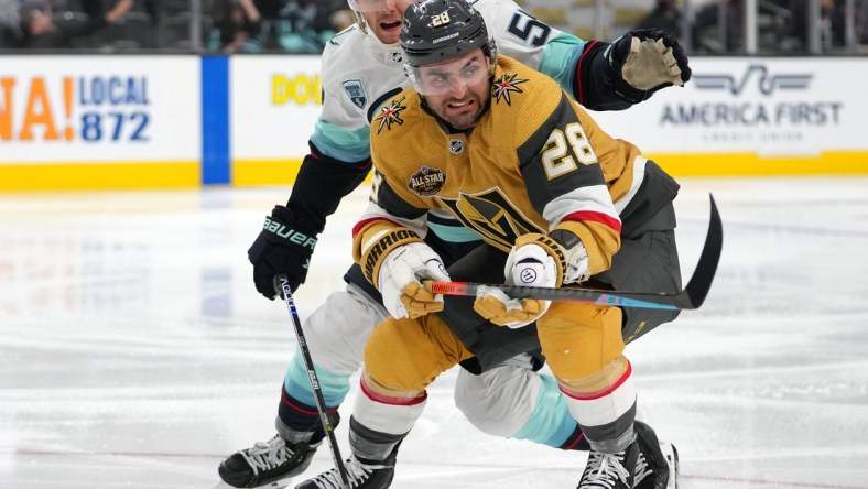 Nov 9, 2021; Las Vegas, Nevada, USA; Seattle Kraken defenseman Jeremy Lauzon (55) keeps pace with Vegas Golden Knights left wing William Carrier (28) during the second period at T-Mobile Arena. Mandatory Credit: Stephen R. Sylvanie-USA TODAY Sports