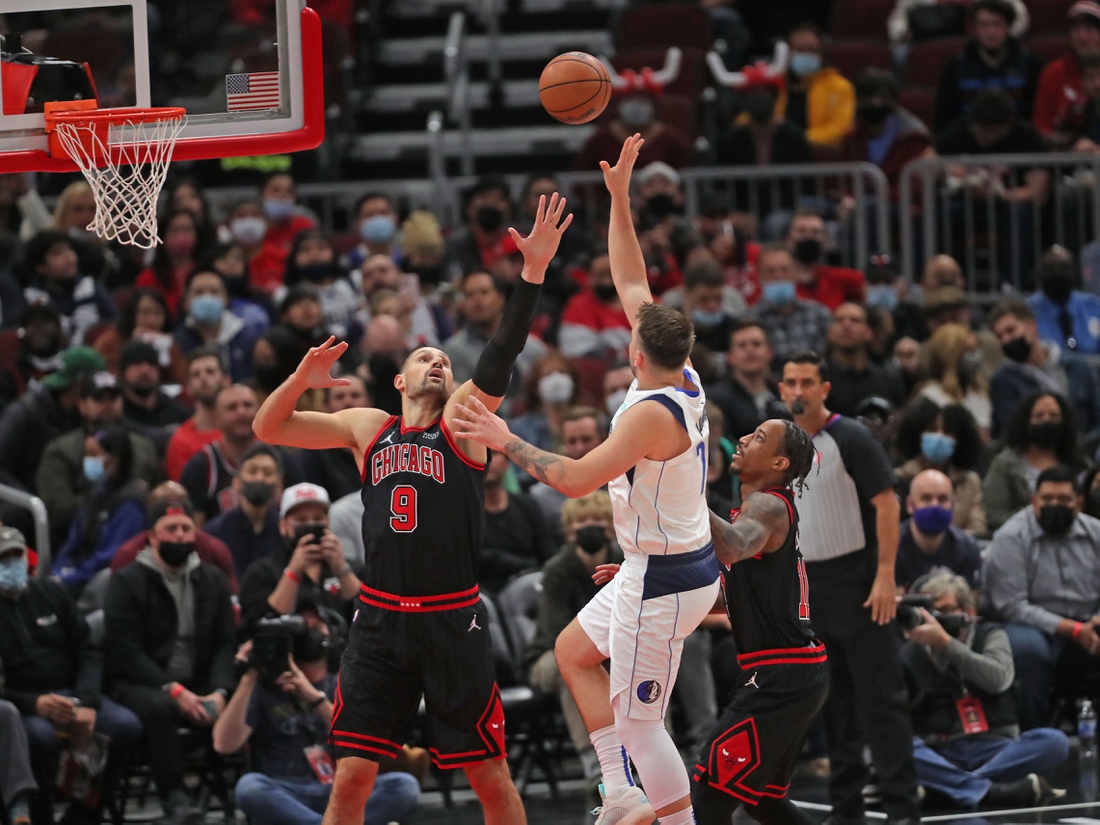 Nov 10, 2021; Chicago, Illinois, USA; Dallas Mavericks guard Luka Doncic (77) shoots over Chicago Bulls center Nikola Vucevic (9) during the first half at the United Center. Mandatory Credit: Dennis Wierzbicki-USA TODAY Sports