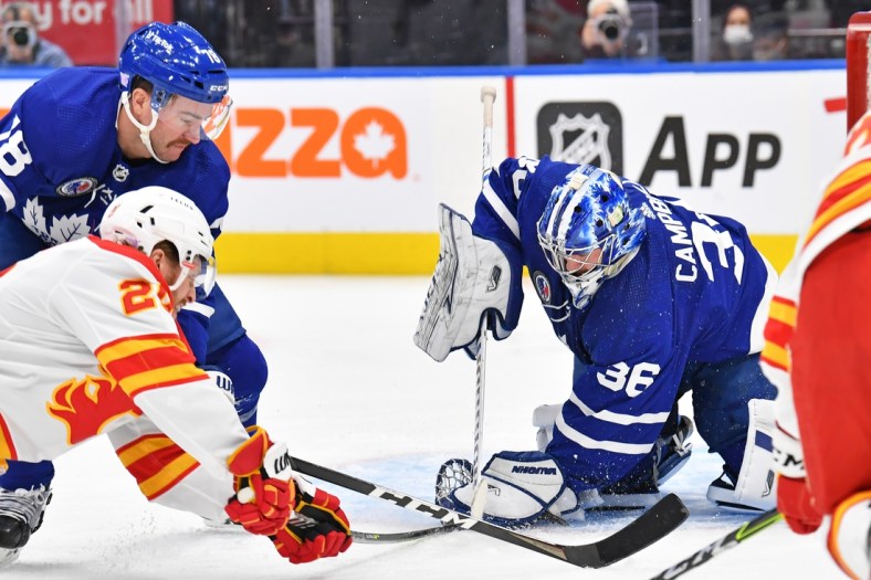 Nov 12, 2021; Toronto, Ontario, CAN; Toronto Maple Leafs goalie Jack Campbell (36) makes a save in front go Calgary Flames center Blake Coleman (20) and Toronto Maple Leafs defenceman T.J. Brodie (78) in the first period at Scotiabank Arena. Mandatory Credit: Gerry Angus-USA TODAY Sports