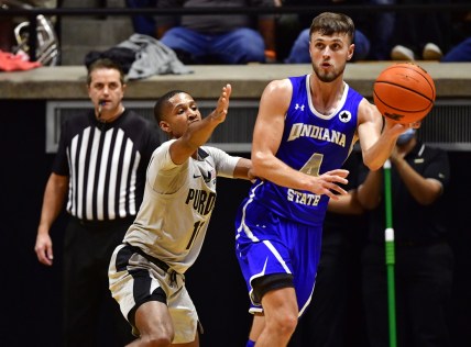Nov 12, 2021; West Lafayette, Indiana, USA; Indiana State Sycamores guard Cooper Neese (4) passes the ball away from Purdue Boilermakers guard Isaiah Thompson (11) during the second half at Mackey Arena. Purdue won 92-67.  Mandatory Credit: Marc Lebryk-USA TODAY Sports