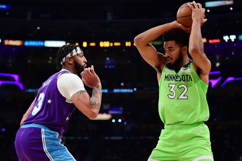 Nov 12, 2021; Los Angeles, California, USA; Minnesota Timberwolves center Karl-Anthony Towns (32) controls the ball against Los Angeles Lakers forward Anthony Davis (3) during the first half at Staples Center. Mandatory Credit: Gary A. Vasquez-USA TODAY Sports