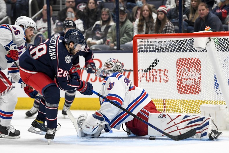Nov 13, 2021; Columbus, Ohio, USA; New York Rangers goaltender Igor Shesterkin (31) makes a leg save against Columbus Blue Jackets right wing Oliver Bjorkstrand (28) in the first period at Nationwide Arena. Mandatory Credit: Gaelen Morse-USA TODAY Sports