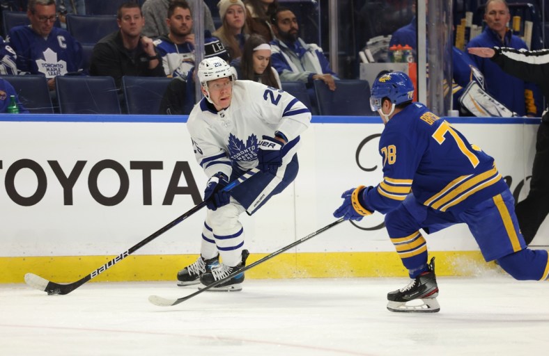 Nov 13, 2021; Buffalo, New York, USA;  Toronto Maple Leafs right wing Ondrej Kase (25) looks to make a pass as Buffalo Sabres defenseman Jacob Bryson (78) defends during the first period at KeyBank Center. Mandatory Credit: Timothy T. Ludwig-USA TODAY Sports