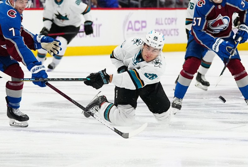 Nov 13, 2021; Denver, Colorado, USA; San Jose Sharks right wing Timo Meier (28) falls as he attempts a shot on goal against the Colorado Avalanche in the first period at Ball Arena. Mandatory Credit: Ron Chenoy-USA TODAY Sports