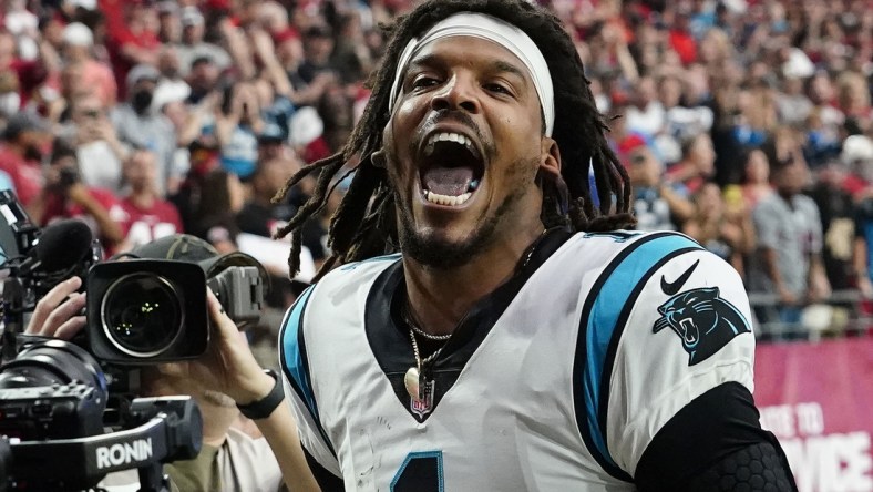 Nov 14, 2021; Glendale, Arizona, USA; Carolina Panthers quarterback Cam Newton (1) yells "I'm back!" after scoring a rushing touchdown against the Arizona Cardinals in the first half at State Farm Stadium.  Mandatory Credit: Rob Schumacher-Arizona Republic via USA TODAY Network