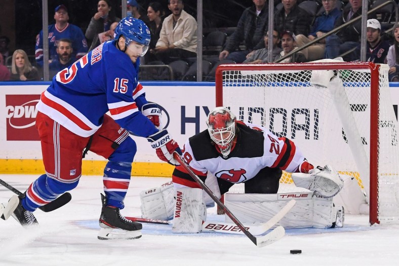 Nov 14, 2021; New York, New York, USA;  New York Rangers right wing Julien Gauthier (15) attempts a hots on New Jersey Devils goaltender Mackenzie Blackwood (29) during the first period at Madison Square Garden. Mandatory Credit: Dennis Schneidler-USA TODAY Sports