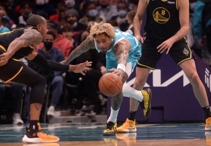 Nov 14, 2021; Charlotte, North Carolina, USA;  Charlotte Hornets guard forward Kelly Oubre Jr. (12) goes after a loose ball during the first half against the Golden State Warriors at the Spectrum Center. Mandatory Credit: Sam Sharpe-USA TODAY Sports