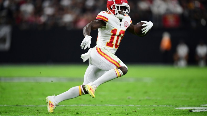 Nov 14, 2021; Paradise, Nevada, USA; Kansas City Chiefs wide receiver Tyreek Hill (10) runs the ball against the Las Vegas Raiders during the first half at Allegiant Stadium. Mandatory Credit: Gary A. Vasquez-USA TODAY Sports