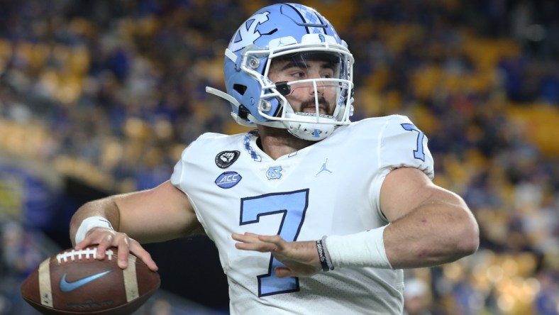 Nov 11, 2021; Pittsburgh, Pennsylvania, USA;  North Carolina Tar Heels quarterback Sam Howell (7) warms up on the sidelines against the Pittsburgh Panthers during the first quarter at Heinz Field. Mandatory Credit: Charles LeClaire-USA TODAY Sports