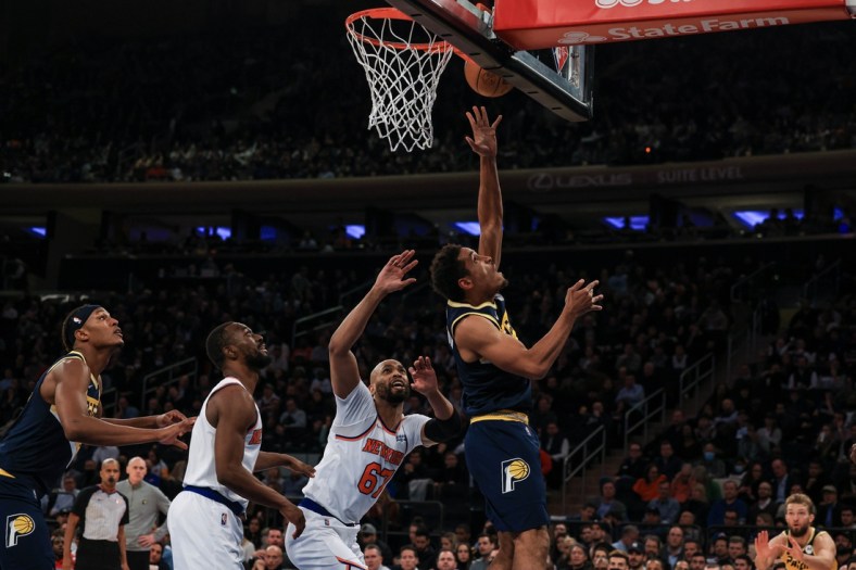 Nov 15, 2021; New York, New York, USA; Indiana Pacers guard Malcolm Brogdon (7) shoots the ball as New York Knicks center Taj Gibson (67) defends during the first half at Madison Square Garden. Mandatory Credit: Vincent Carchietta-USA TODAY Sports