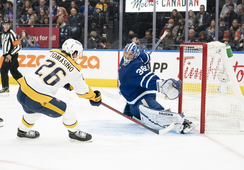 Nov 16, 2021; Toronto, Ontario, CAN;  Nashville Predators center Philip Tomasino (26) charges the net on Toronto Maple Leafs goaltender Jack Campbell (36) during the first period  at Scotiabank Arena. Mandatory Credit: Nick Turchiaro-USA TODAY Sports