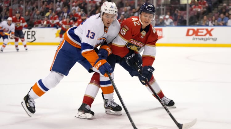 Nov 16, 2021; Sunrise, Florida, USA; New York Islanders center Mathew Barzal (13) and Florida Panthers defenseman Gustav Forsling (42) battle for the puck during the first period at FLA Live Arena. Mandatory Credit: Jasen Vinlove-USA TODAY Sports