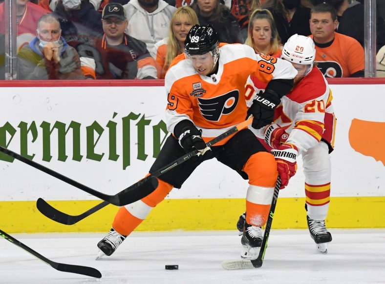 Nov 16, 2021; Philadelphia, Pennsylvania, USA; Philadelphia Flyers right wing Cam Atkinson (89) battle for the puck with Calgary Flames center Blake Coleman (20) during the first period at Wells Fargo Center. Mandatory Credit: Eric Hartline-USA TODAY Sports