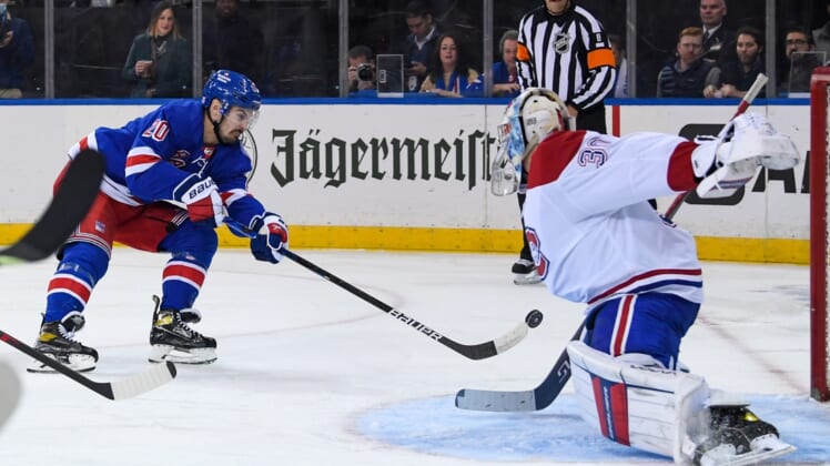 Nov 16, 2021; New York, New York, USA; New York Rangers left wing Chris Kreider (20) shots the puck and scores against Montreal Canadiens goaltender Cayden Primeau (30) during the second period at Madison Square Garden. Mandatory Credit: Dennis Schneidler-USA TODAY Sports