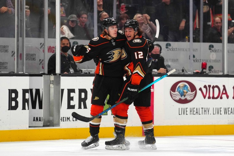 Nov 16, 2021; Anaheim, California, USA; Anaheim Ducks center Trevor Zegras (46) celebrates with left wing Sonny Milano (12) after scoring a goal against the Washington Capitals in the third period at Honda Center. The Ducks defeated the Capitals 3-2 in overtime. Mandatory Credit: Kirby Lee-USA TODAY Sports