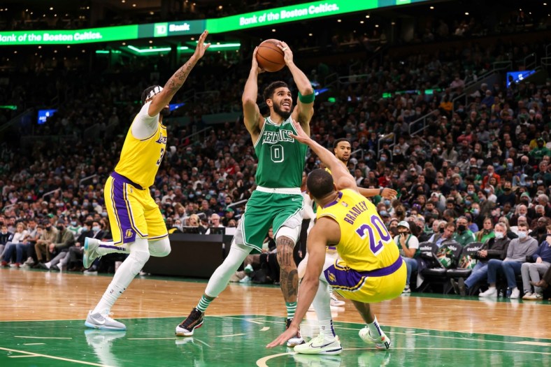 Nov 19, 2021; Boston, Massachusetts, USA; Boston Celtics forward Jayson Tatum (0) drives to the basket defended by Los Angeles Lakers guard Avery Bradley (20) and Los Angeles Lakers forward Anthony Davis (3) during the first half at TD Garden. Mandatory Credit: Paul Rutherford-USA TODAY Sports