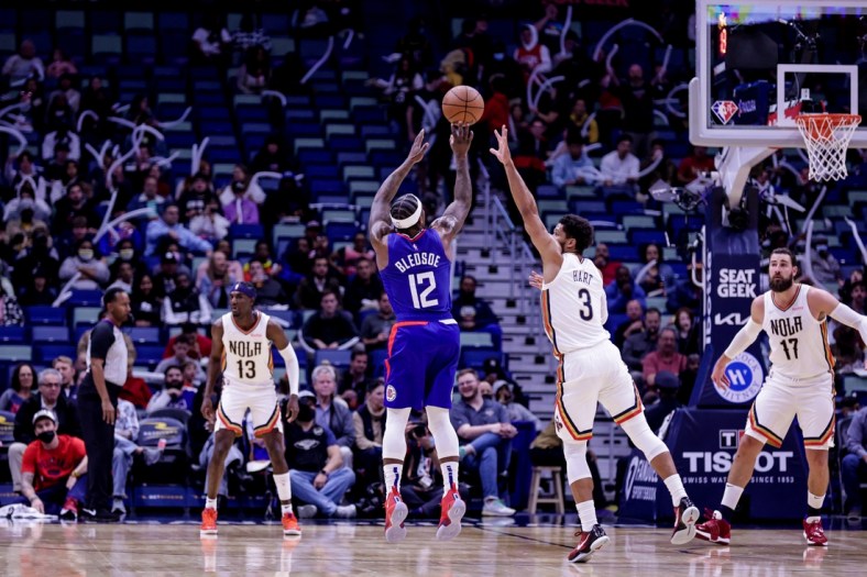 Nov 19, 2021; New Orleans, Louisiana, USA;  LA Clippers guard Eric Bledsoe (12) shoots a jump shot against New Orleans Pelicans guard Josh Hart (3) during the first half at Smoothie King Center. Mandatory Credit: Stephen Lew-USA TODAY Sports