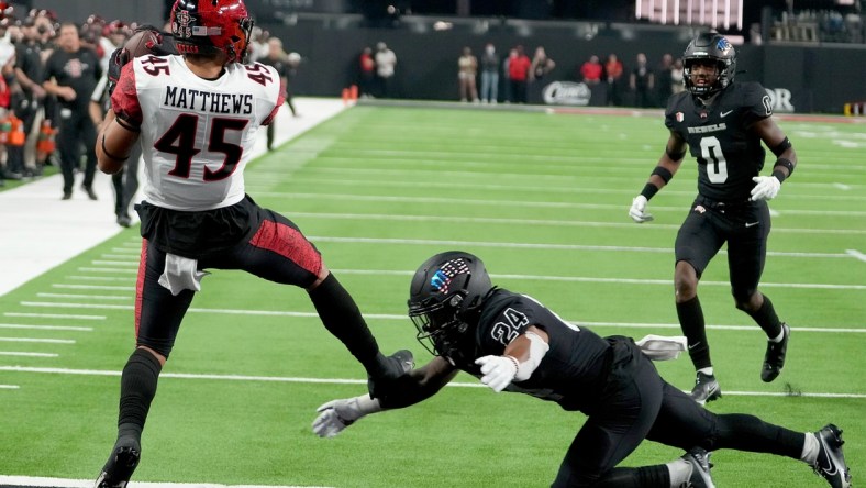 Nov 19, 2021; Paradise, Nevada, USA; San Diego State Aztecs wide receiver Jesse Matthews (45) makes a touchdown reception against UNLV Rebels defensive back Bryce Jackson (24) at Allegiant Stadium. Mandatory Credit: Stephen R. Sylvanie-USA TODAY Sports